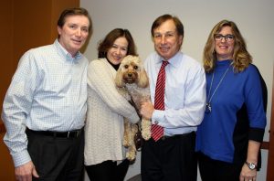 Photo: The Forum Group staff with a dog.