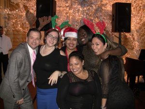 Photo: The Forum Group staff at a holiday event.
