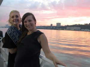 Photo: 2 members of The Forum Group staff on a boat.